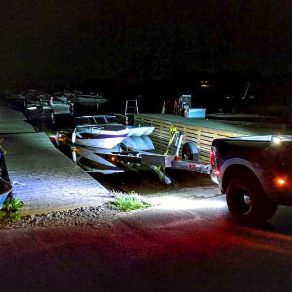 Pickup Truck Loading Boat on Trailer in the Dark Pickup Truck Loading Boat on Trailer in the Dark