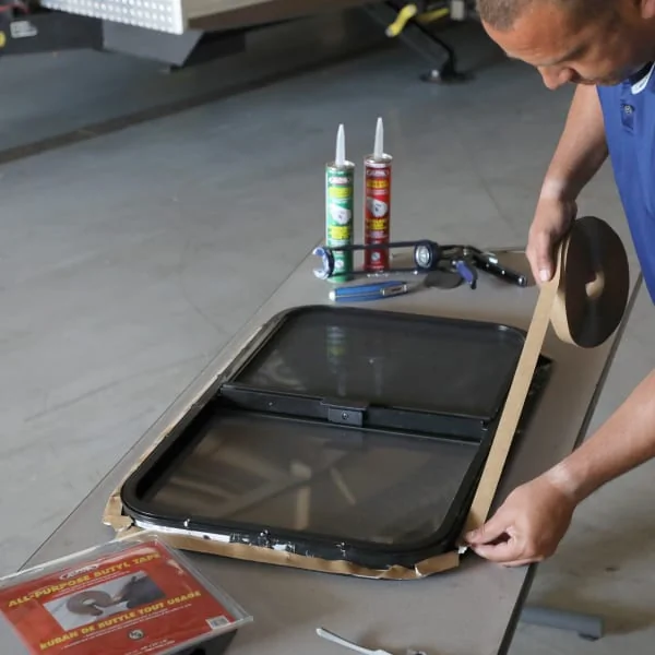 Person uses RV tape to repair a leak