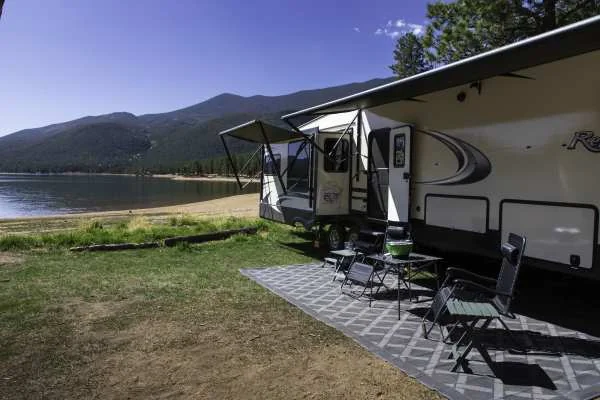 Campsite setup with RV awning and stairs