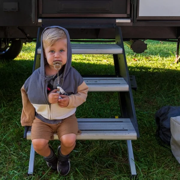 Child sitting on a Lippert RV entry step