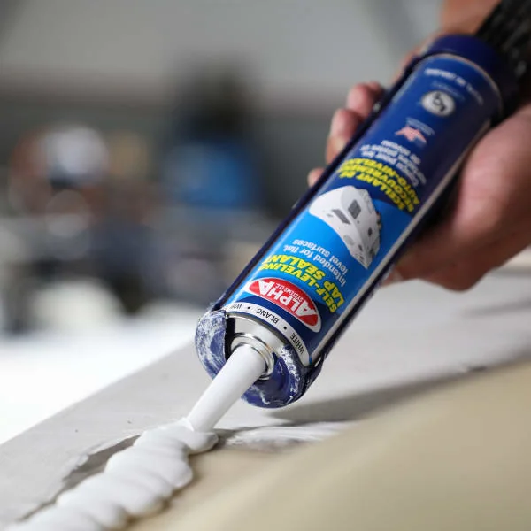 Alpha RV roof sealant being applied with a caulk gun