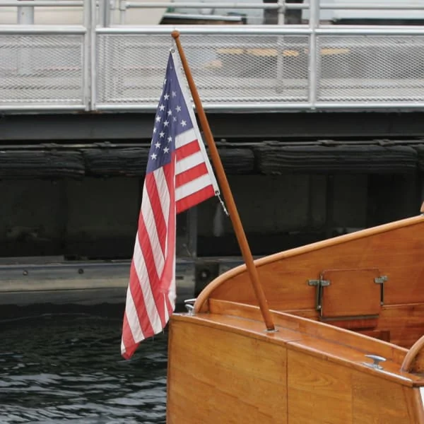 American Flag Flying from a Teak Flagpole on Wooden Boat American Flag Flying from a Teak Flagpole on Wooden Boat
