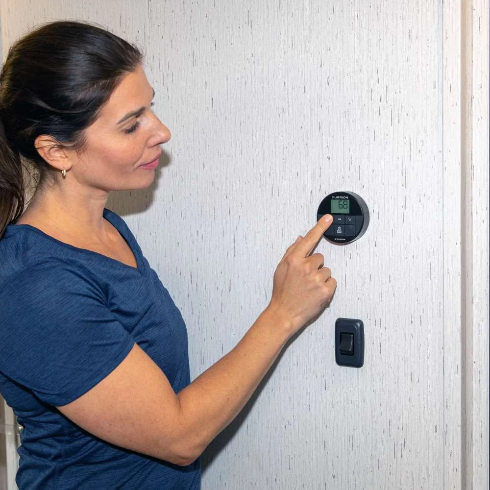 Woman Adjusting RV AC Thermostat