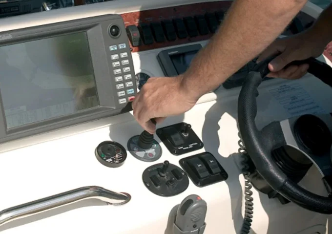 Boater Using a Joystick to Control a Boat Thruster Boater Using a Joystick to Control a Boat Thruster