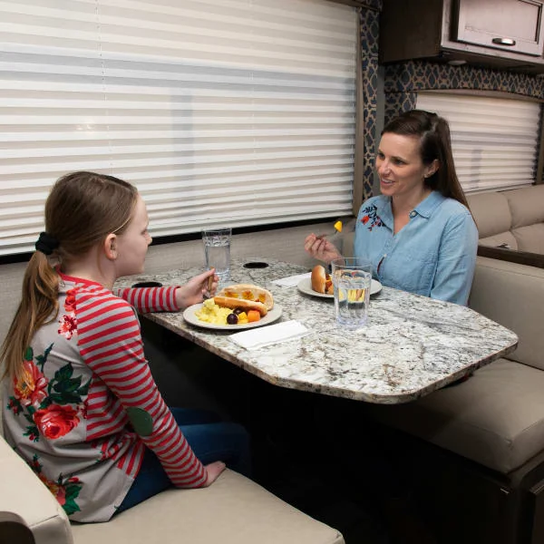 Family eating meal on dishes that will be placed in an RV dishwasher