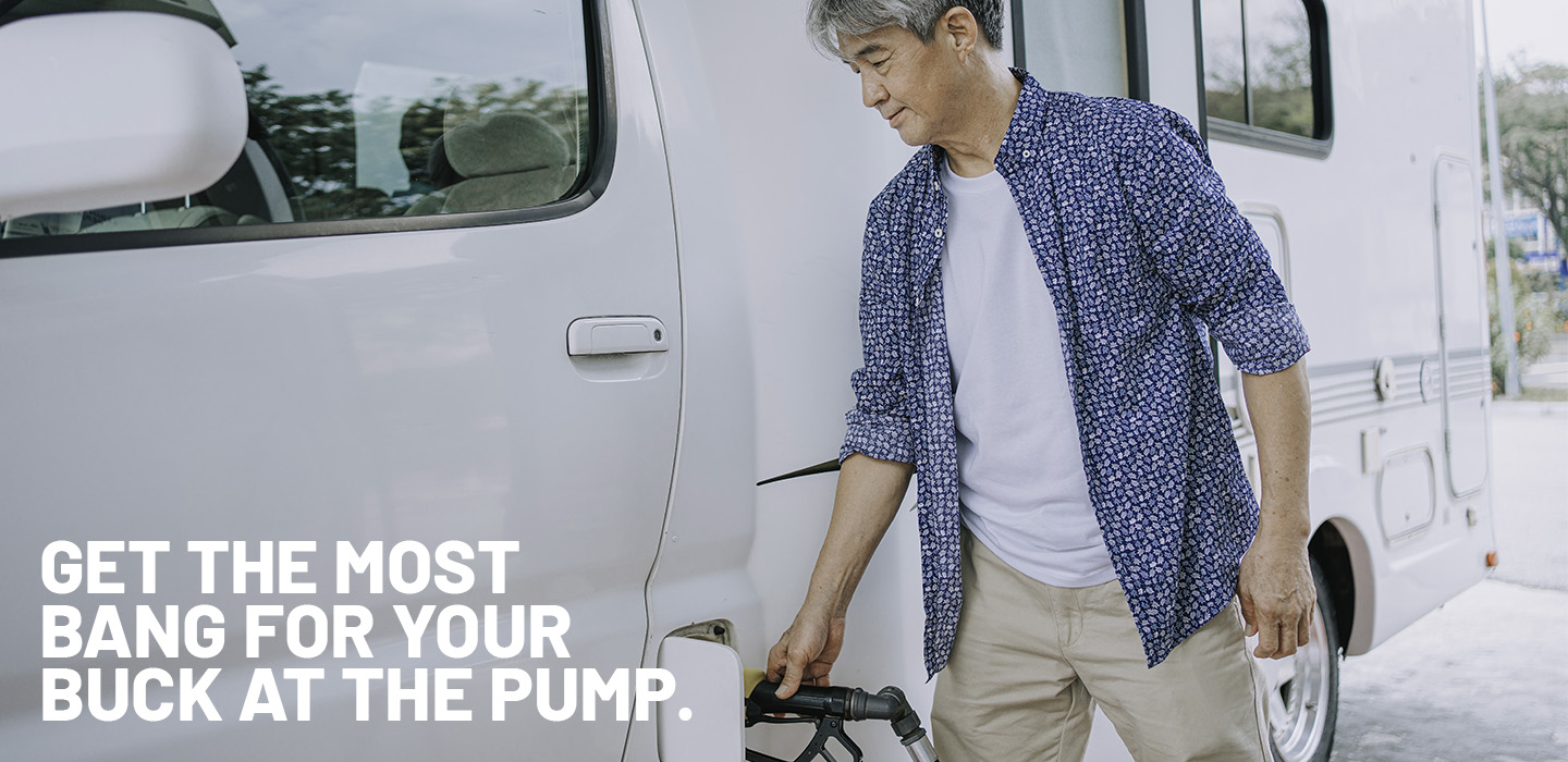 Man fueling his RV at a gas station
