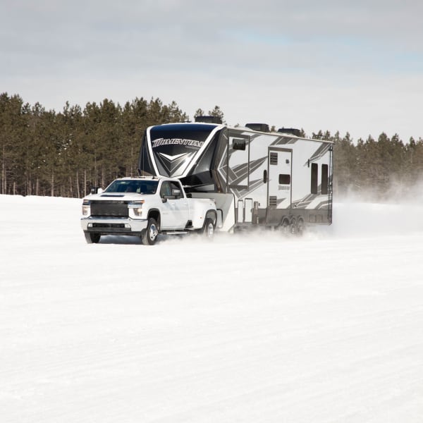 5th-wheel RV being pulled on a snowy road