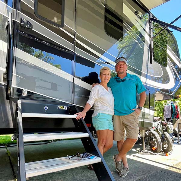 The Campoholics posing with their Grand Design Momentum RV