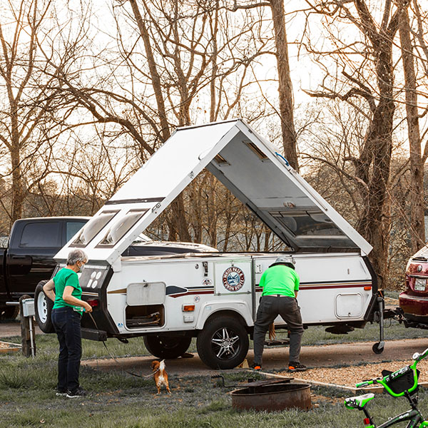 Camping Couple Setting up A-frame Camper