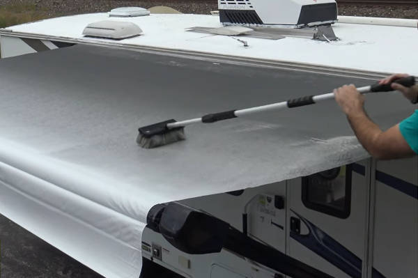 Brush awning with soapy water