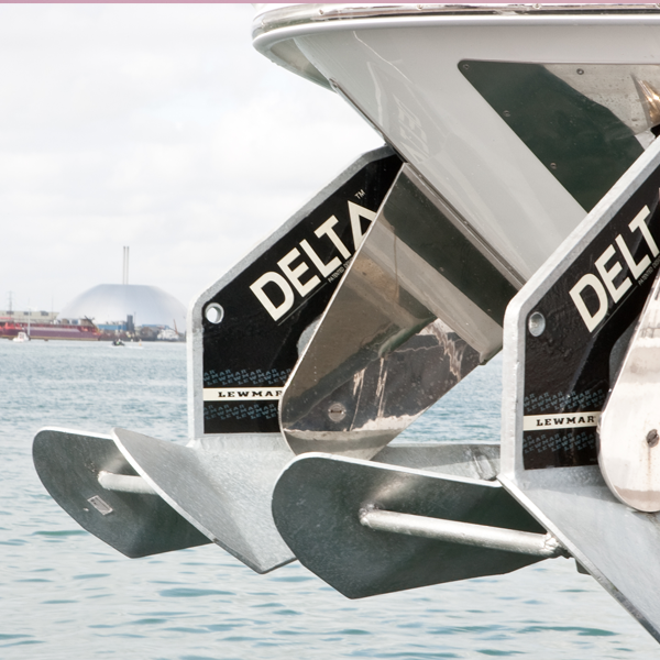 Delta boat anchor hung from boat - guide to boat anchor types