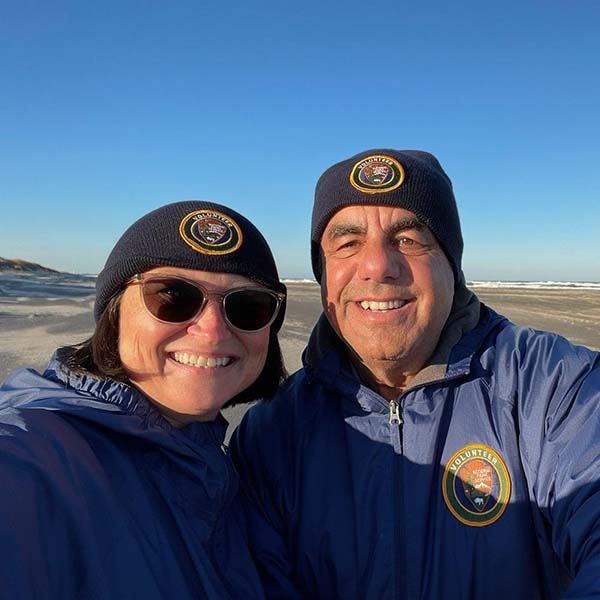 Donna and Vic on the beach at a volunteer site