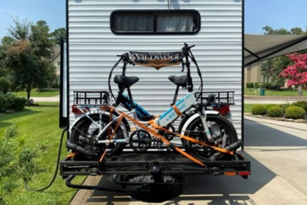 Flip-down cargo carrier with ebikes loaded and secured