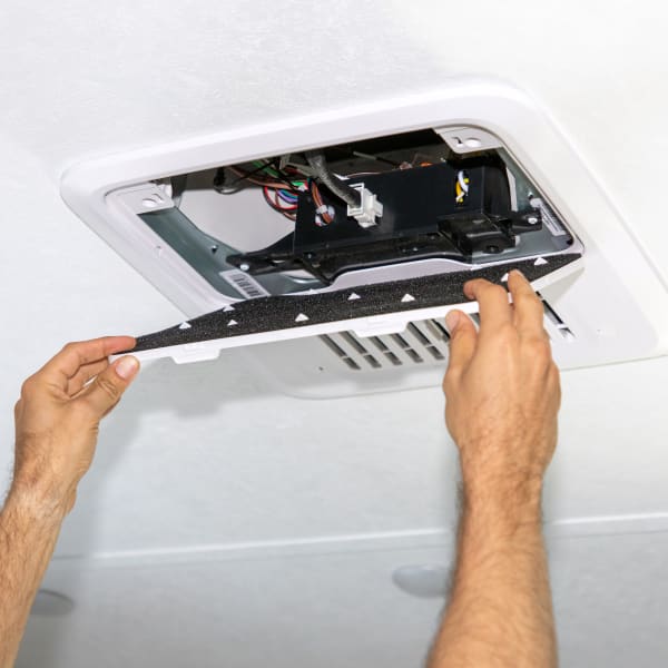 RV technician replacing RV AC filter