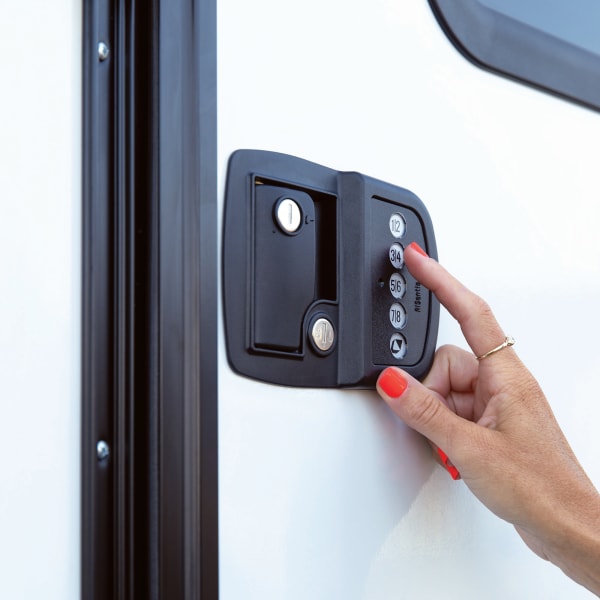 Person using a keyless RV door lock with Bluetooth technology