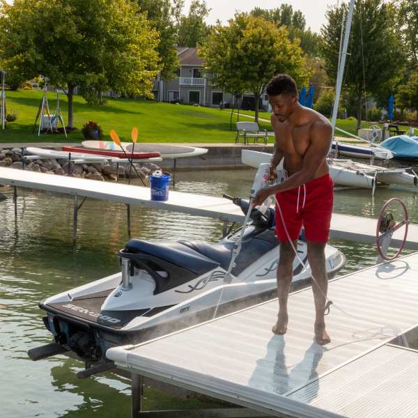 A man power washing his dock A man power washing his dock