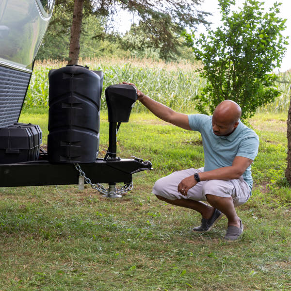 Camper man operating electric tongue jack