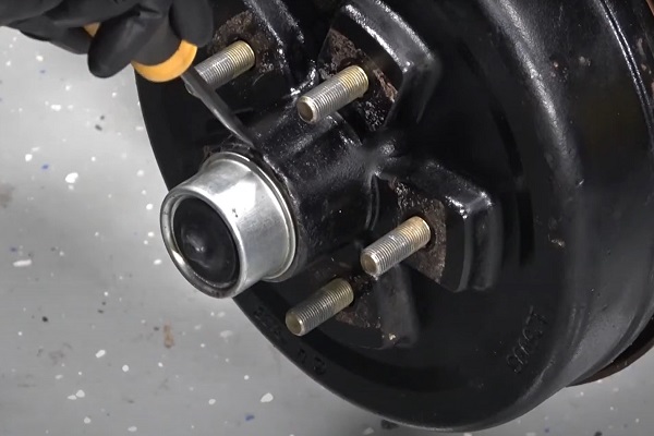 Removing dust cap for a trailer brake assembly replacement