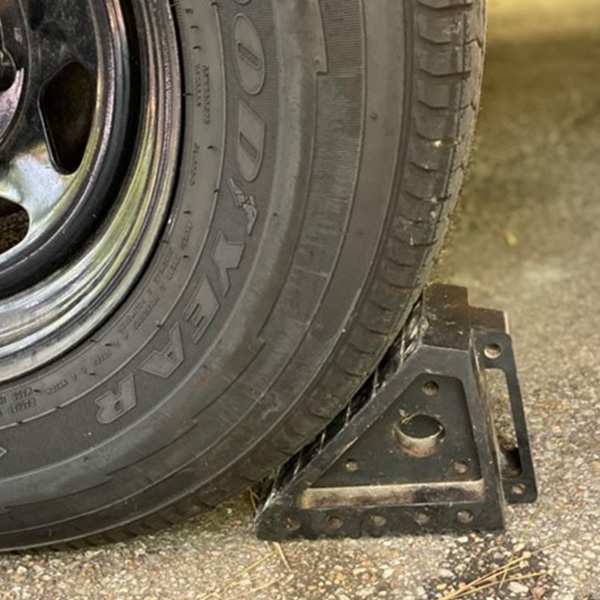 Rubber wheel chocks holding RV tire in place