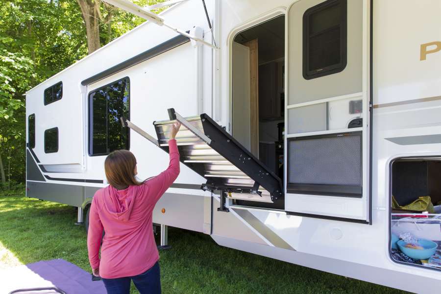 Woman storing RV steps into her RV