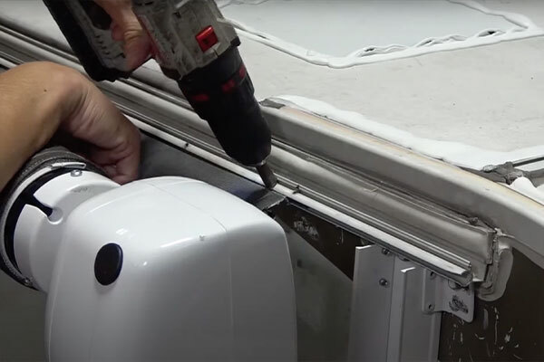 Detach the awning tube from head assemblies and feed fabric through awning rail