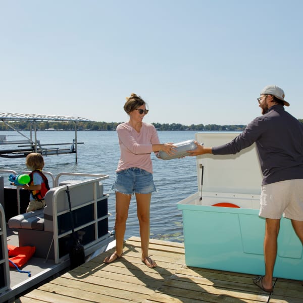 Boaters storing fenders in the best dock box for their needs