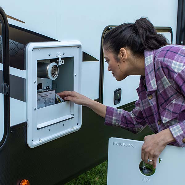Woman inspecting her RV water heater