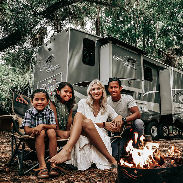 The Axeness family sitting around a campfire