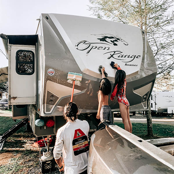 Nate of ProjectTrek washing his RV with his kids
